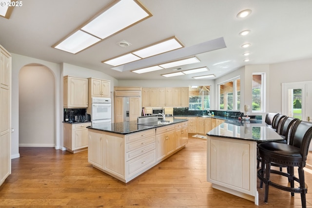 92631 Rainier Ln, Coos Bay, OR 97420 - kitchen with a breakfast bar, healthy amount of natural light, recessed lighting, a kitchen island with sink, and tasteful backsplash