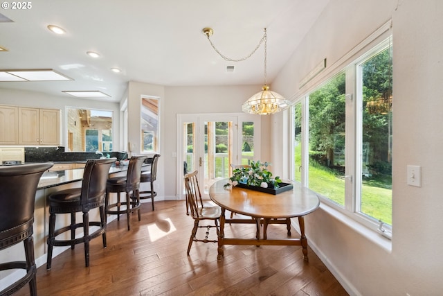 92631 Rainier Ln, Coos Bay, OR 97420 - dining room with healthy amount of natural light, wood-type flooring, recessed lighting, and a chandelier