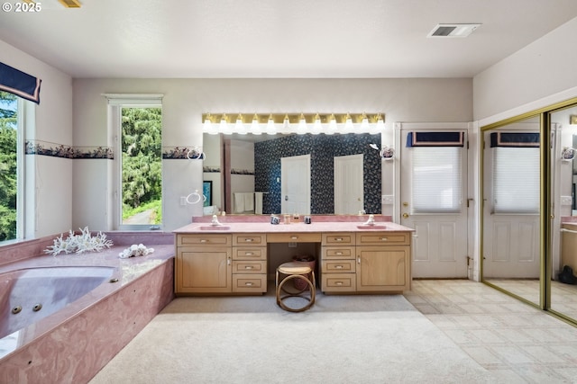 92631 Rainier Ln, Coos Bay, OR 97420 - bathroom with plenty of natural light, vanity, a whirlpool tub, and tile patterned floors