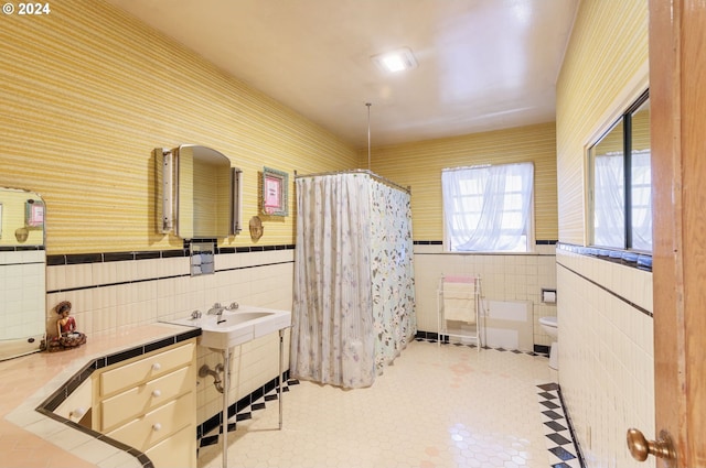 bathroom featuring tile walls, walk in shower, vanity, and toilet