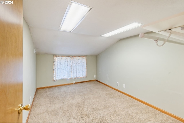 bonus room featuring light carpet and vaulted ceiling