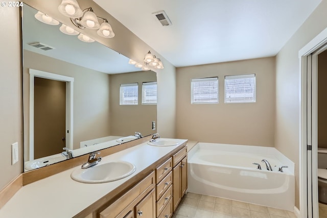 bathroom featuring toilet, a tub, and vanity