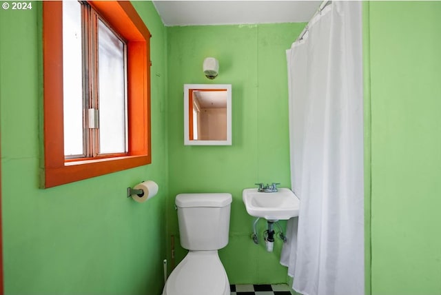 bathroom featuring toilet and tile patterned flooring