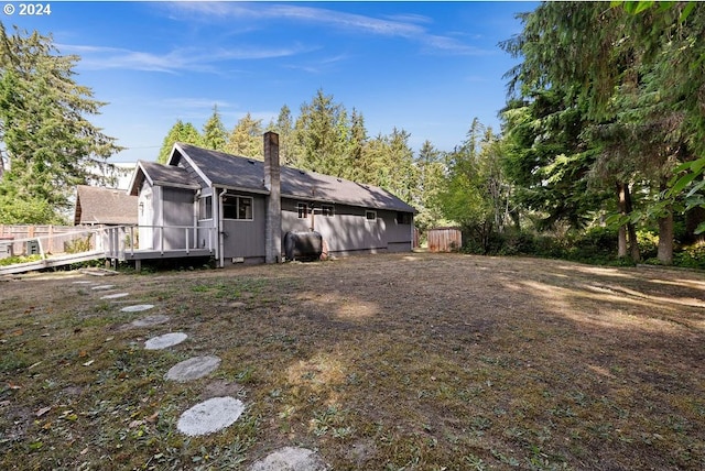 rear view of house featuring a deck