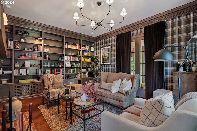 sitting room featuring a notable chandelier, crown molding, dark wood-type flooring, and built in features