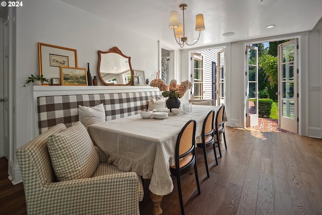 dining area with an inviting chandelier and hardwood / wood-style flooring