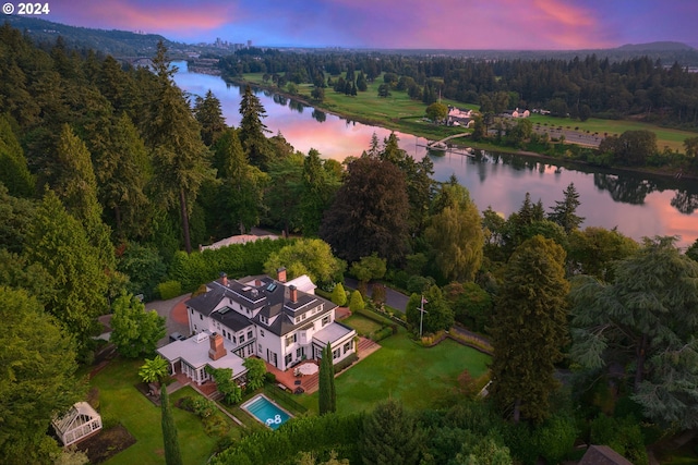 aerial view at dusk with a water view