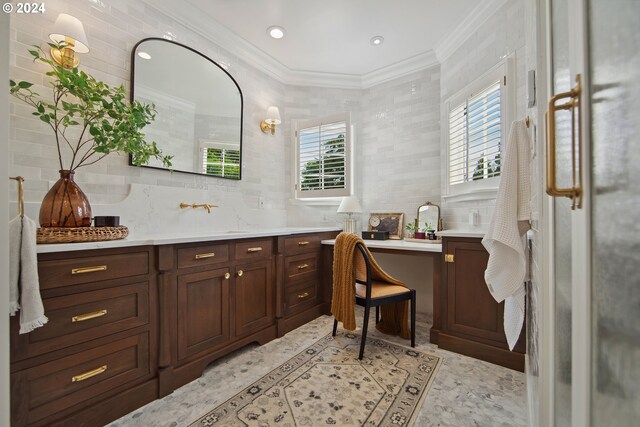 bathroom featuring decorative backsplash, tile walls, vanity, and crown molding