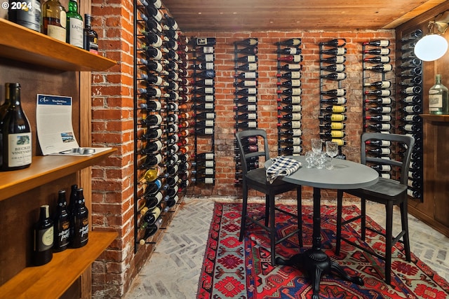 wine area with brick wall and wooden ceiling