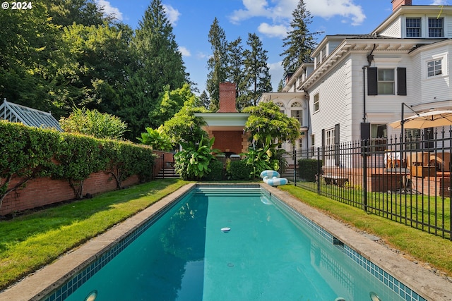 view of swimming pool with a lawn