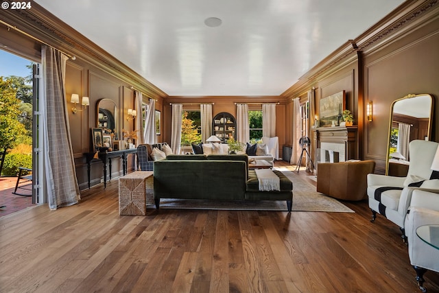 living room featuring wood-type flooring and crown molding