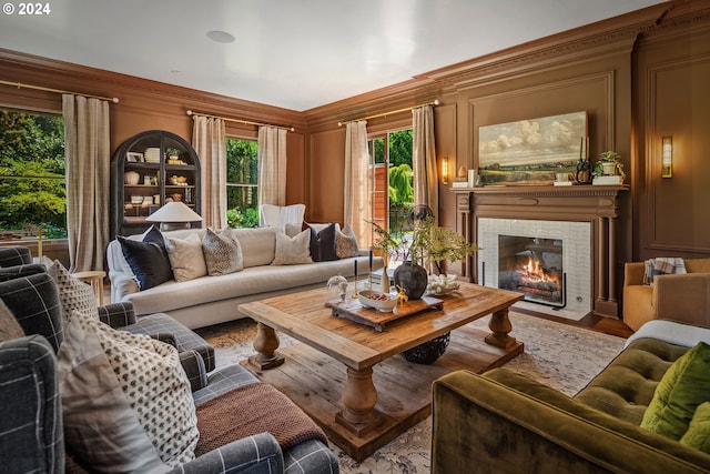 living room featuring crown molding and a tiled fireplace