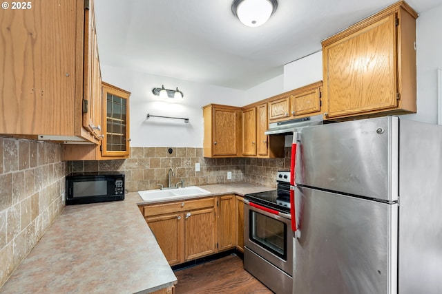 kitchen with dark hardwood / wood-style flooring, sink, stainless steel appliances, and tasteful backsplash