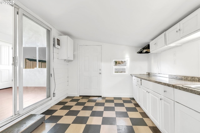 kitchen with white cabinets and vaulted ceiling