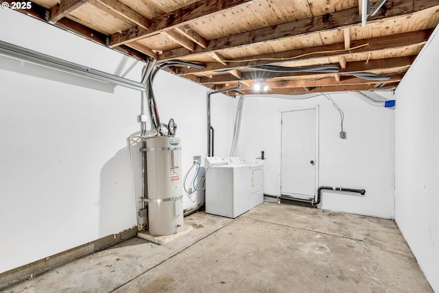 basement featuring secured water heater and washer and clothes dryer