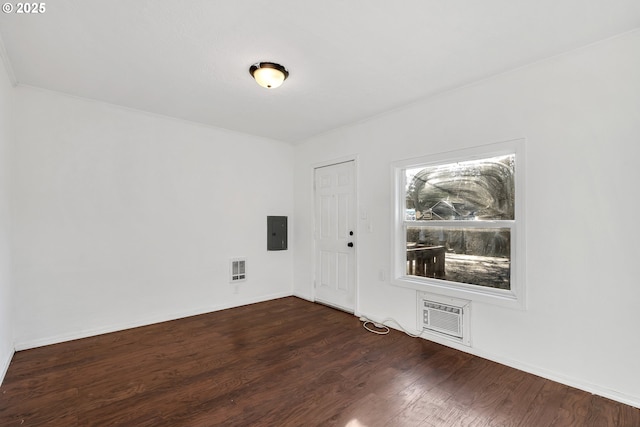 unfurnished room with electric panel and dark wood-type flooring