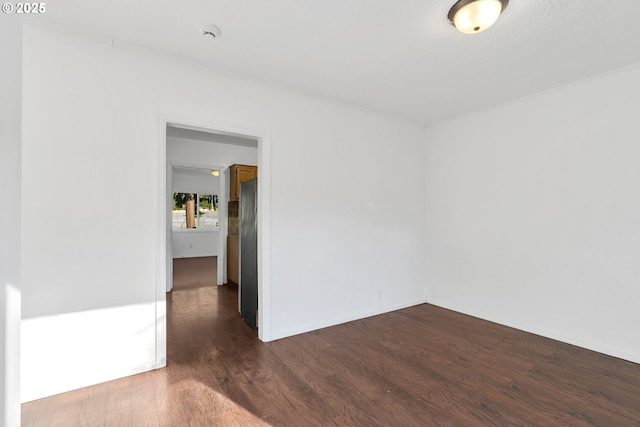 unfurnished room with dark hardwood / wood-style floors