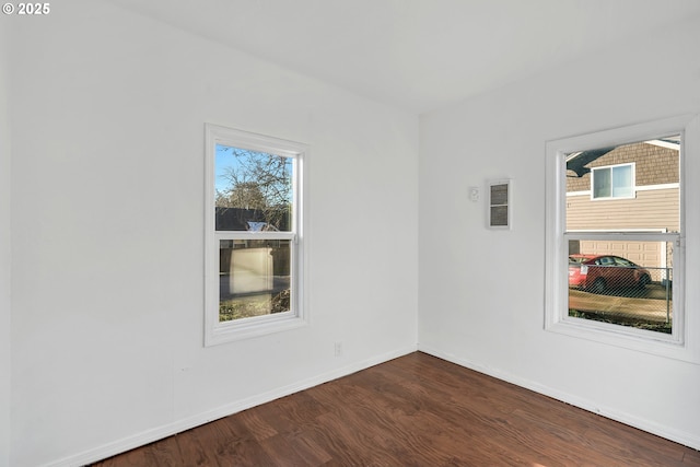 empty room with dark hardwood / wood-style flooring