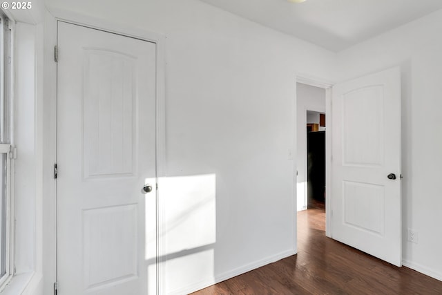 unfurnished bedroom featuring dark wood-type flooring