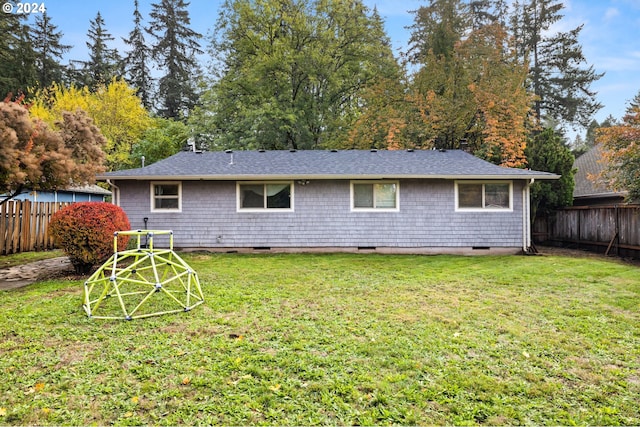 rear view of house with a lawn