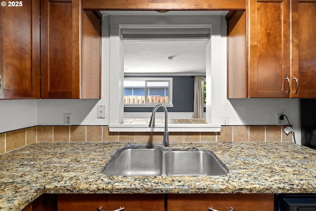 18021 Tualata Ave, Lake Oswego, OR 97035 - kitchen featuring light stone countertops, brown cabinetry, and backsplash