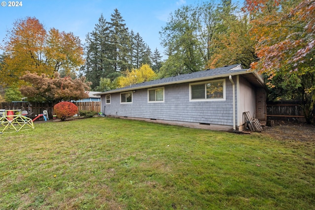 back of house with a lawn