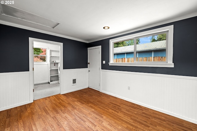 18021 Tualata Ave, Lake Oswego, OR 97035 - empty room featuring wainscoting, healthy amount of natural light, wood finished floors, and ornamental molding