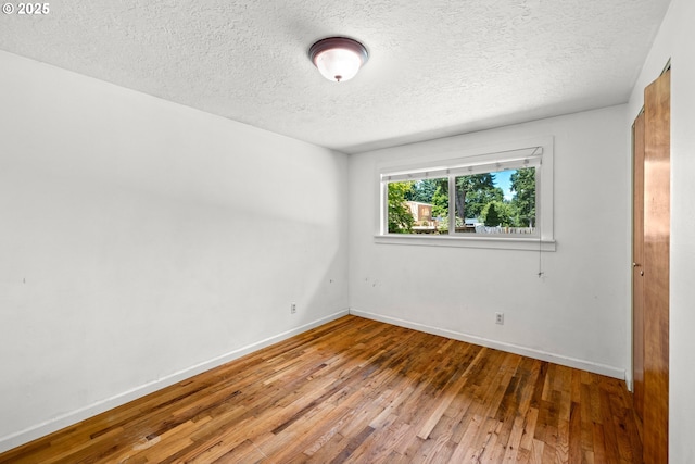 18021 Tualata Ave, Lake Oswego, OR 97035 - unfurnished bedroom with wood-type flooring and a textured ceiling