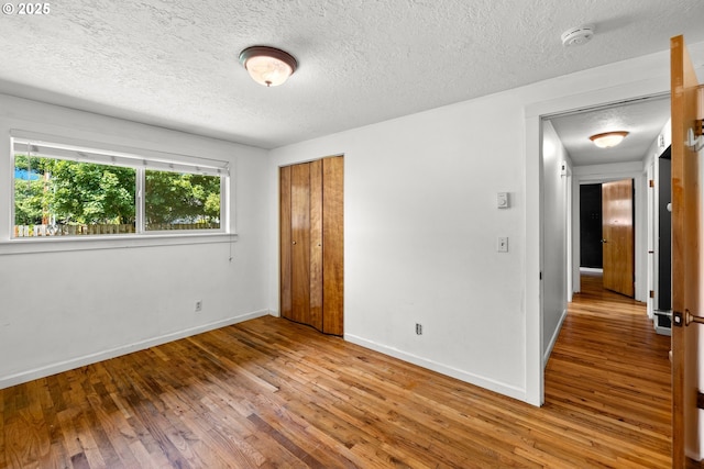 18021 Tualata Ave, Lake Oswego, OR 97035 - unfurnished bedroom featuring hardwood / wood-style flooring, a textured ceiling, and a closet