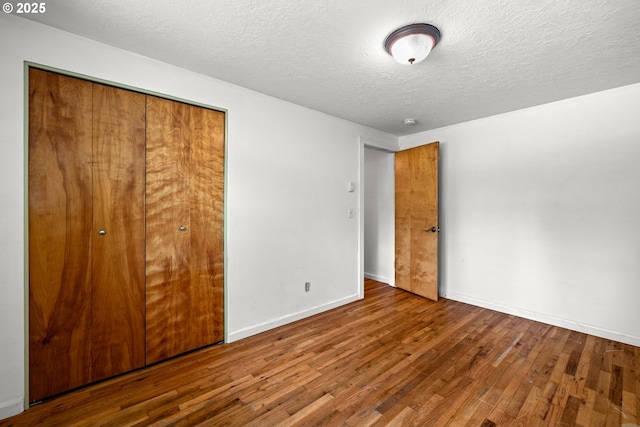 18021 Tualata Ave, Lake Oswego, OR 97035 - unfurnished bedroom featuring wood finished floors, a closet, and a textured ceiling