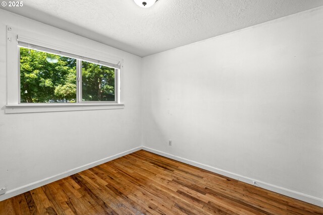 18021 Tualata Ave, Lake Oswego, OR 97035 - unfurnished room featuring hardwood / wood-style flooring and a textured ceiling