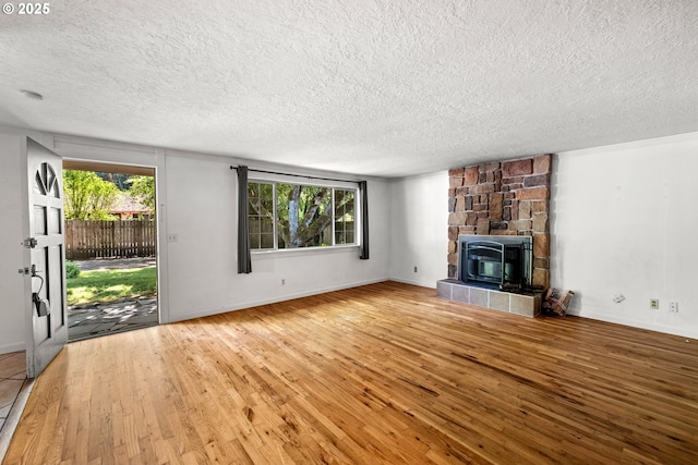 18021 Tualata Ave, Lake Oswego, OR 97035 - unfurnished living room with a textured ceiling, wood finished floors, plenty of natural light, and a fireplace