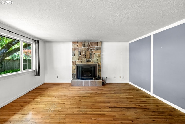 18021 Tualata Ave, Lake Oswego, OR 97035 - unfurnished living room featuring a textured ceiling, wood finished floors, and a tiled fireplace