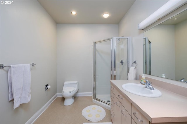 bathroom with vanity, a shower with shower door, and toilet