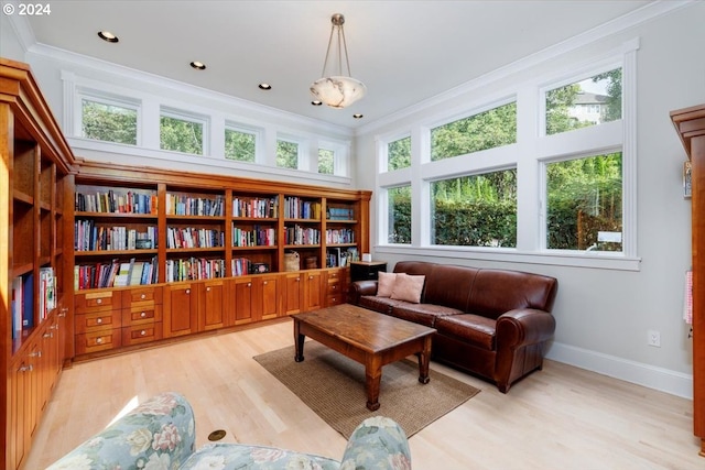 sitting room featuring light wood-type flooring and ornamental molding