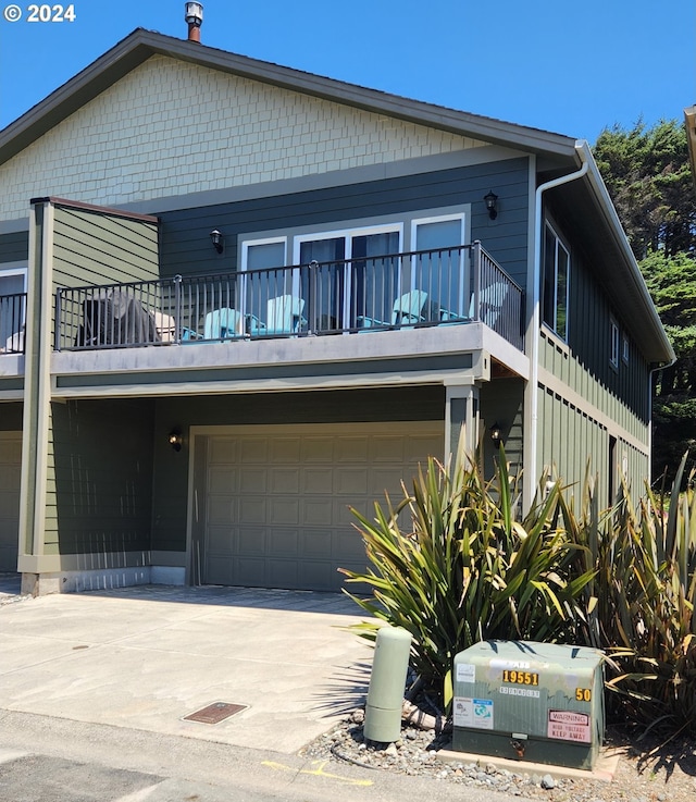 view of front of house with a balcony and a garage