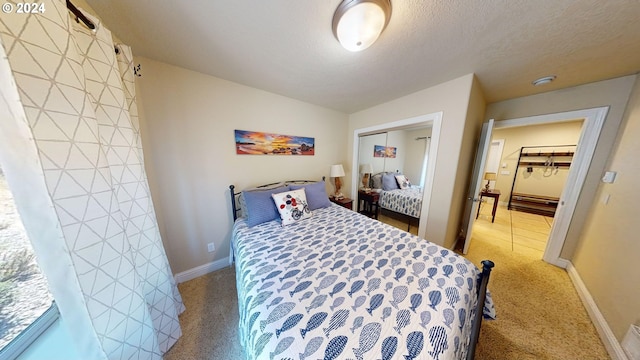 carpeted bedroom featuring a closet and a textured ceiling