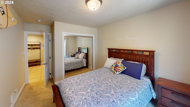 bedroom featuring light carpet and a closet