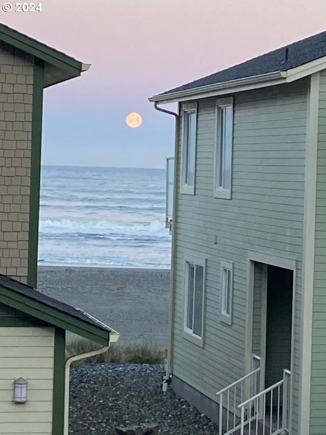 property exterior at dusk with a water view