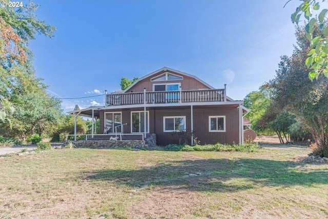 rear view of property featuring a yard