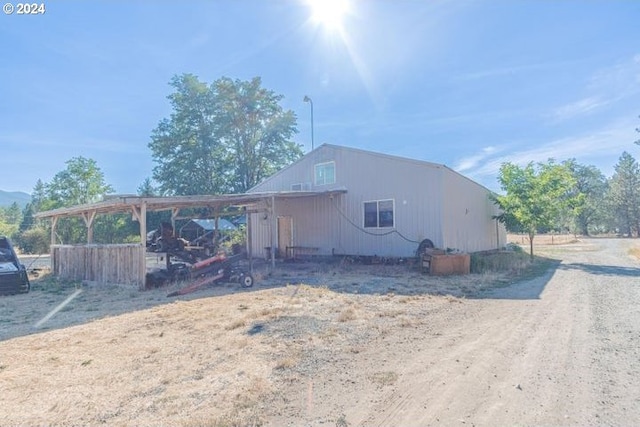 back of property with a carport