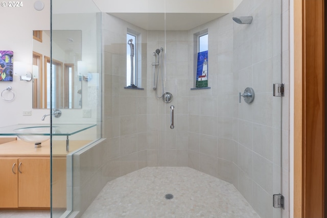 bathroom with walk in shower and vanity