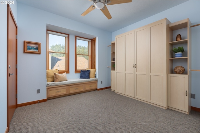 unfurnished bedroom featuring ceiling fan, light colored carpet, and multiple closets