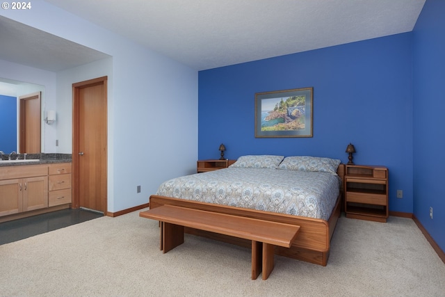 bedroom featuring sink and dark carpet