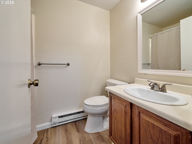 bathroom with a baseboard radiator, wood-type flooring, toilet, and vanity