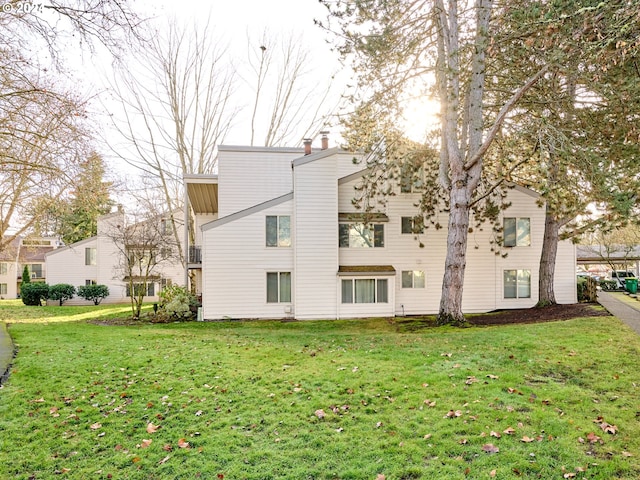 view of property exterior with a lawn