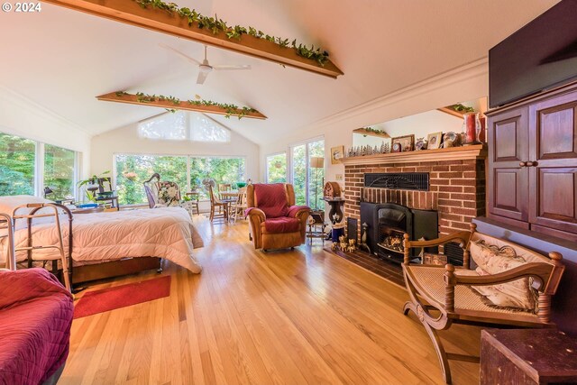 bedroom featuring beamed ceiling, a fireplace, high vaulted ceiling, and light hardwood / wood-style floors