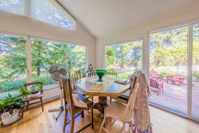 sunroom / solarium featuring vaulted ceiling and a wealth of natural light