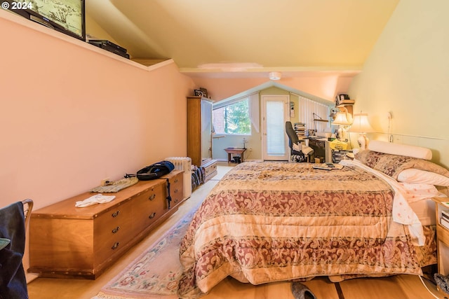 bedroom with access to exterior and vaulted ceiling