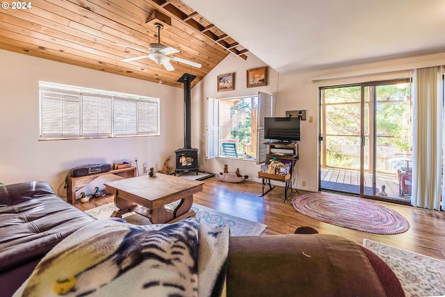 living room featuring wood ceiling, lofted ceiling, wood-type flooring, and a wood stove